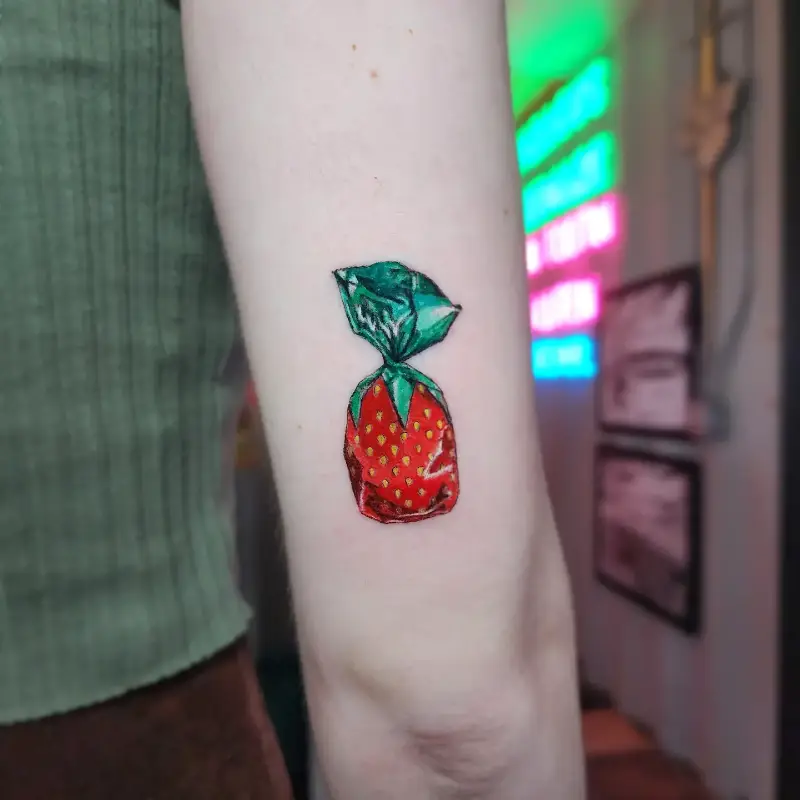 Whimsical Wrapped Candy Strawberry Tattoo